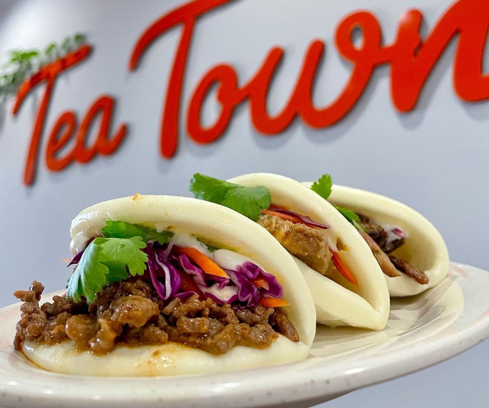 Three house-made bao buns filled with KBBQ, slaw and cilantro