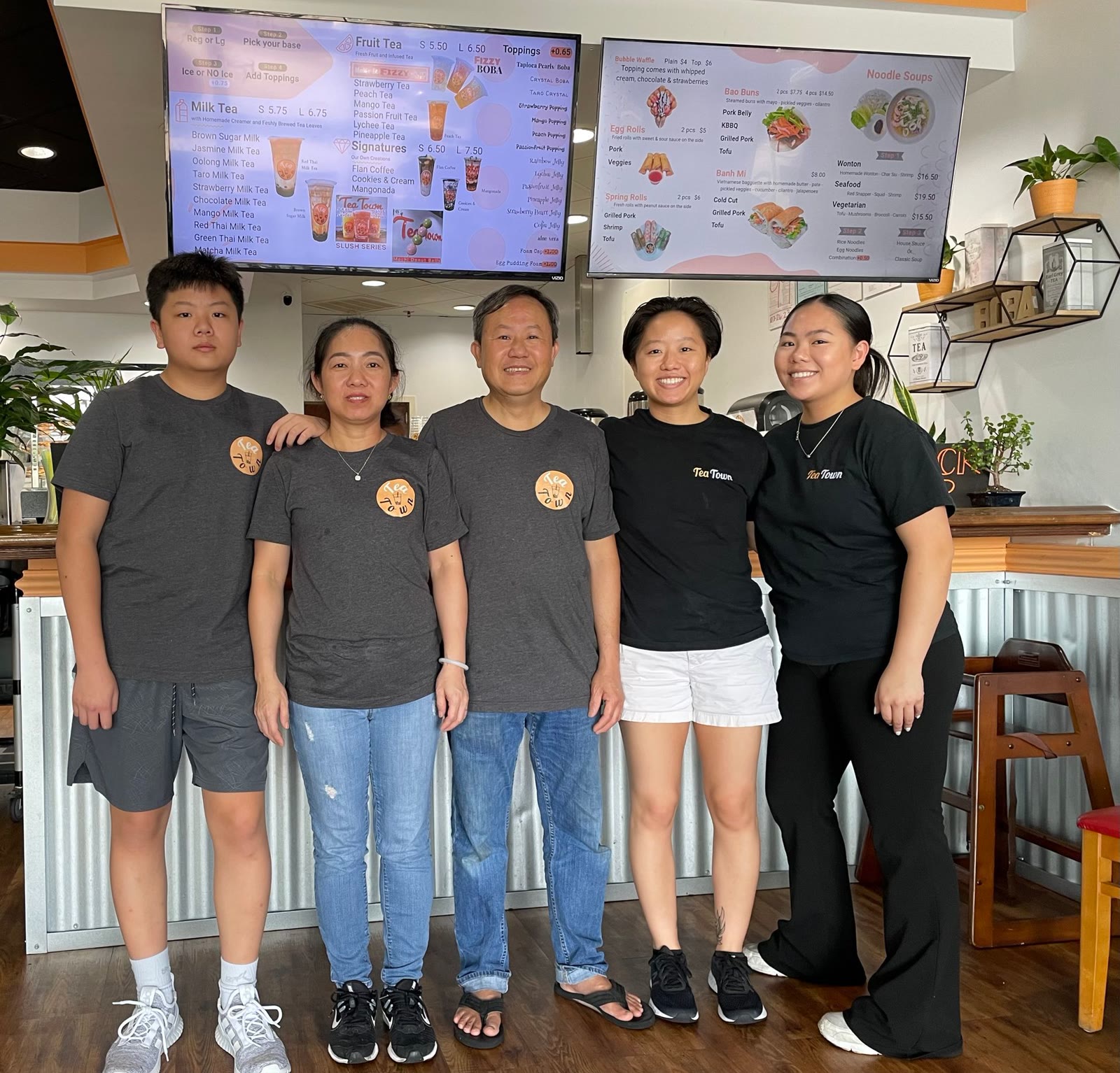 The Tea Town Montgomery family standing together inside the shop