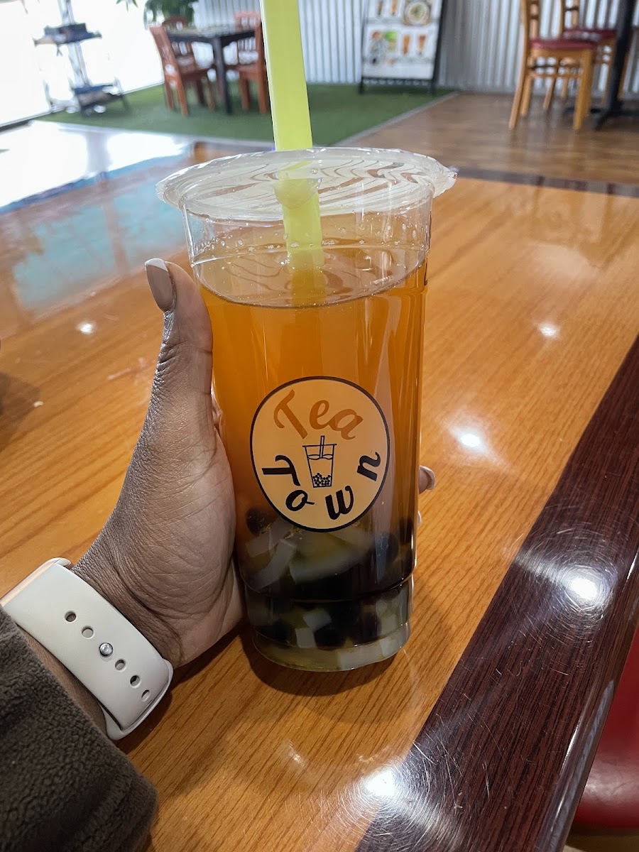 A fruit tea with boba held at Tea Town